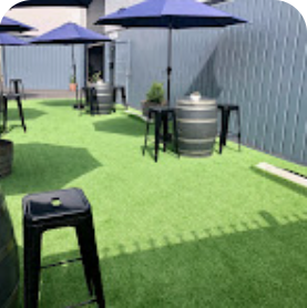 eureka brewing company outside patio area with tables, chairs and shade umbrellas